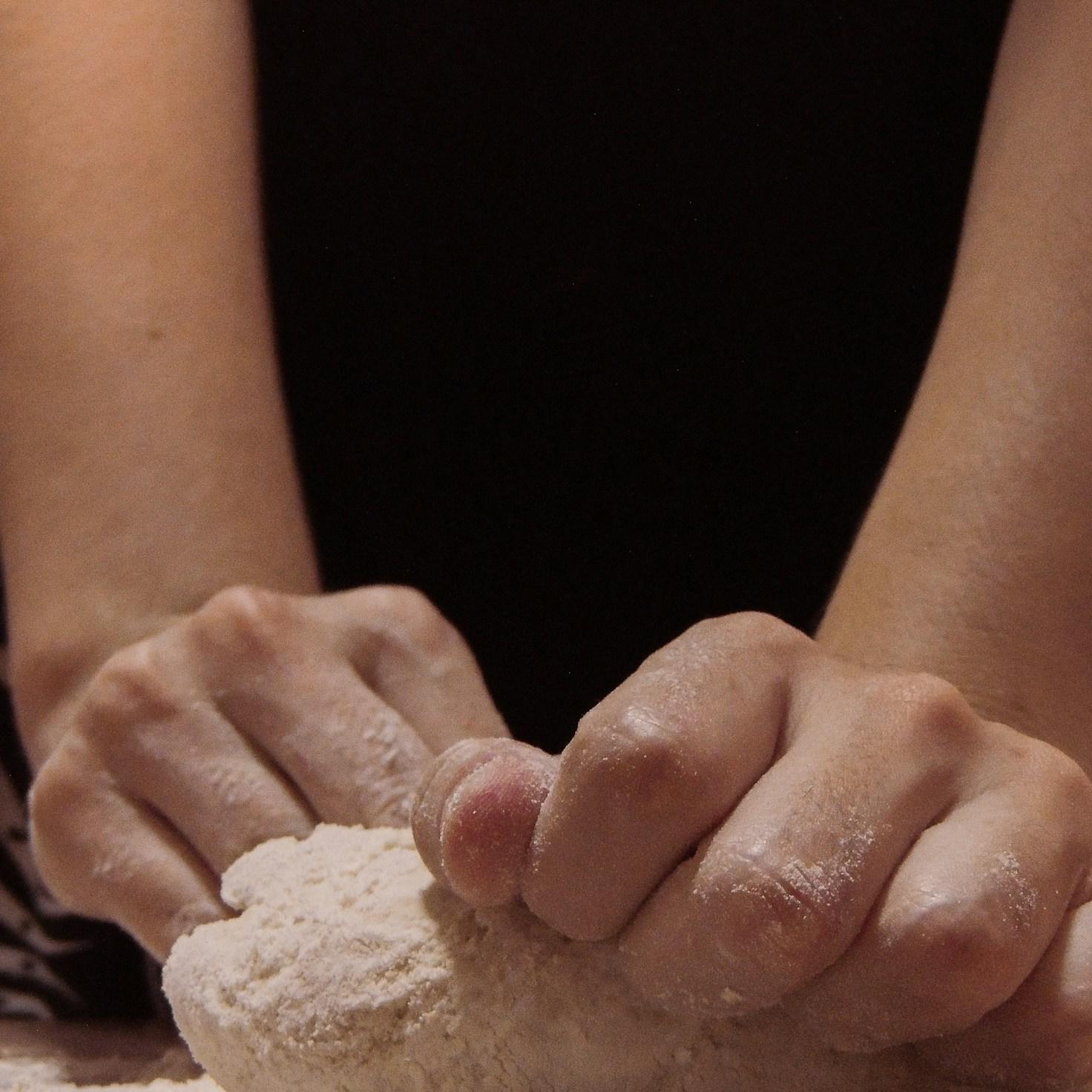 Community members collaborating in a modern kitchen space, sharing recipes and cooking techniques